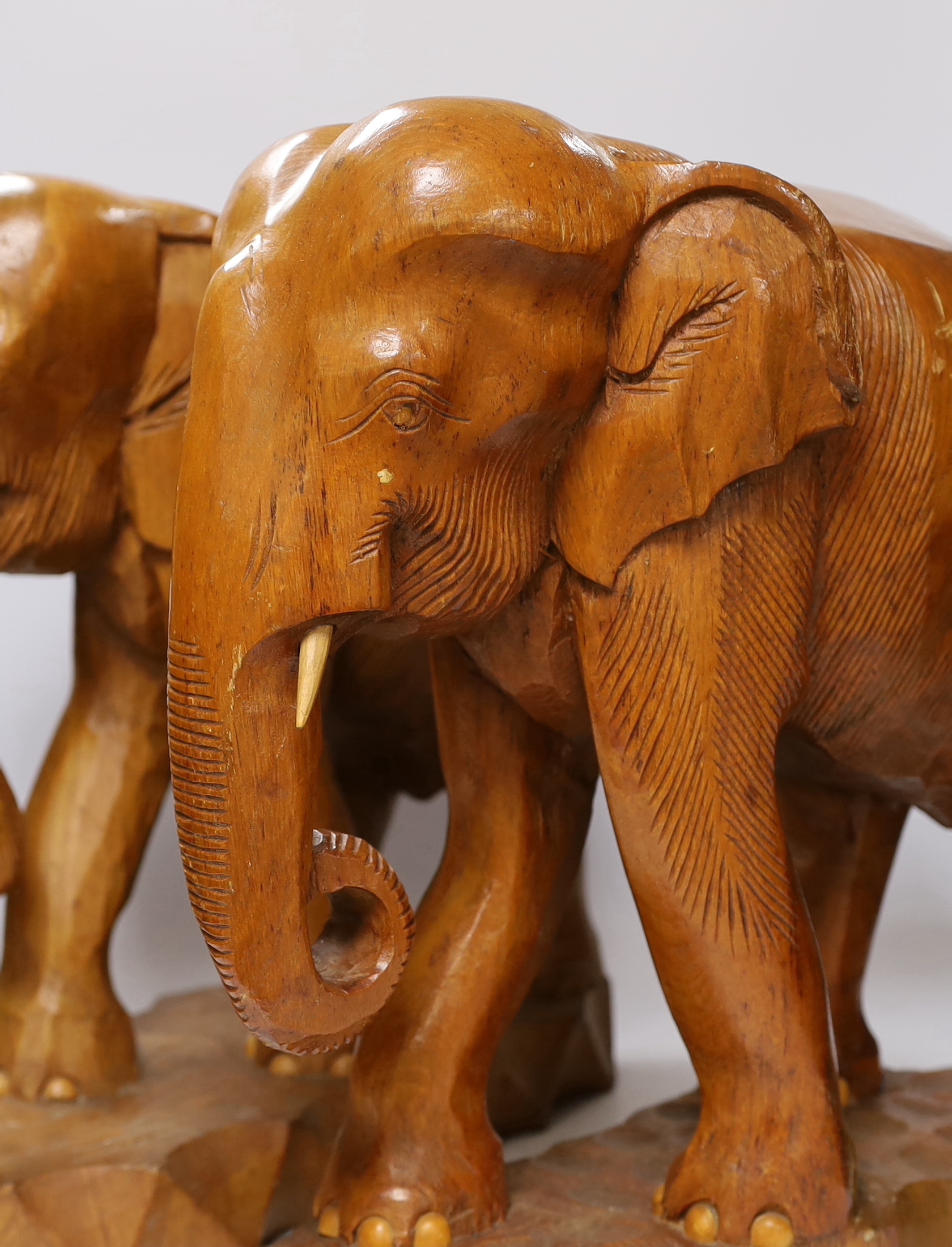 A pair of carved teak elephants, 42cm high